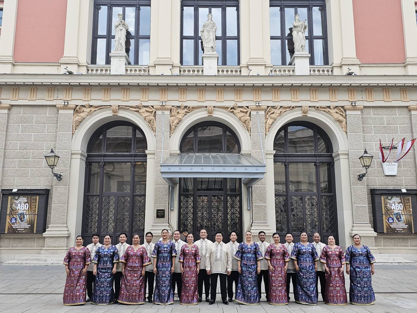 The Madz in Filipino terno and barong in front of a European concert hall
